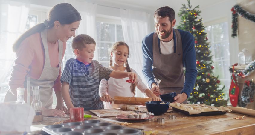 Portrait of Cute Children Helping their Parents Bake at Home for Christmas.