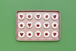 Homemade linzer cookies on a pink tray, top view