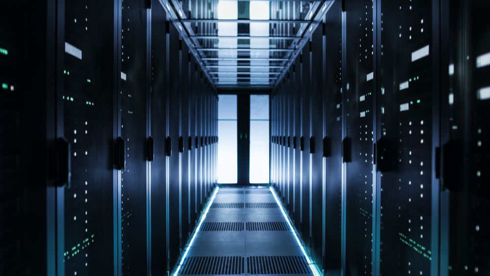 Shot of Corridor in Working Data Center Full of Rack Servers and Supercomputers.