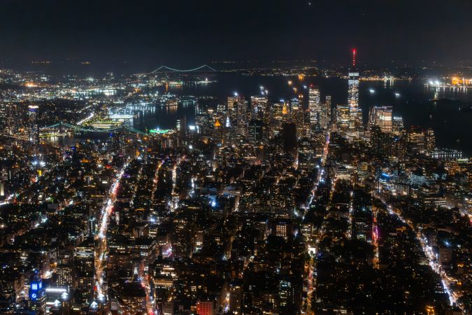 Helicopter Tour of New York City Architecture at Night. Fly-By Over Midtown Manhattan Office Buildings and Skyscrapers. Aerial Urban Landscape with Lights at Night