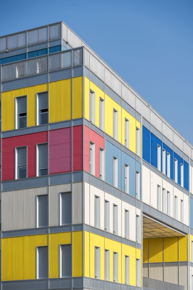 Facade of modern multicolored building with narrow windows