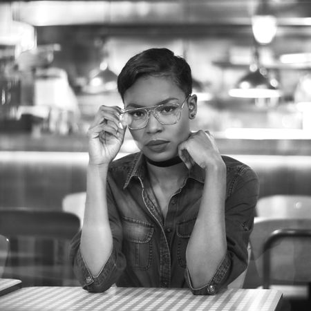 Monochrome image of woman at cafe table