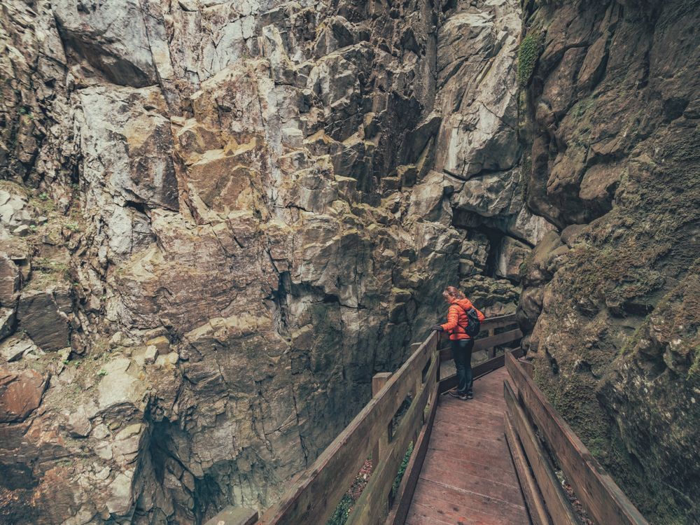 Traveller admiring picturesque view of mountain ridge