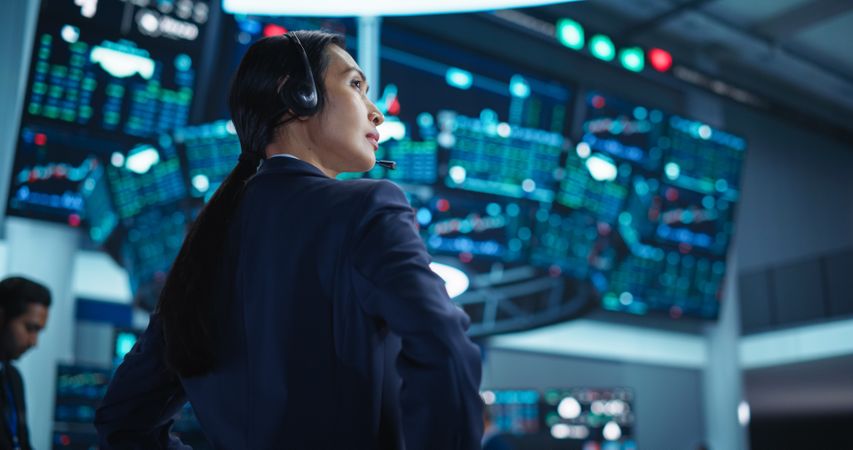 Portrait of a Young Stock Exchange Broker Using Tablet Computer, Researching Real-Time Stocks Data, Analyzing Commodities and Exchange Market Charts.