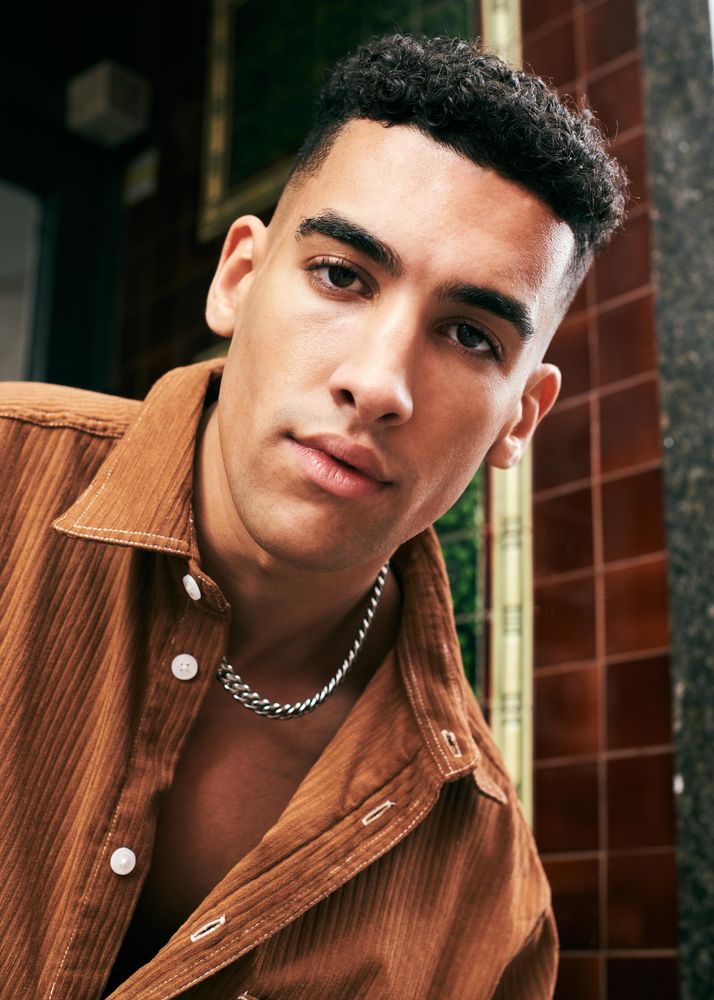 Portrait of man in corduroy shirt and silver chain