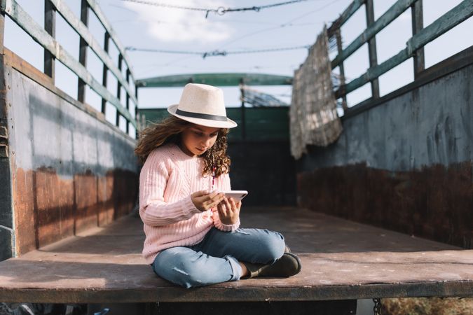 Focused girl using smartphone in countryside