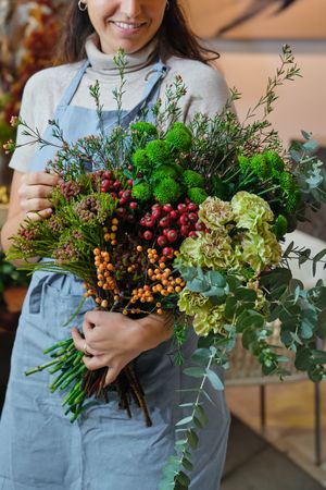 Crop woman with flower bouquet