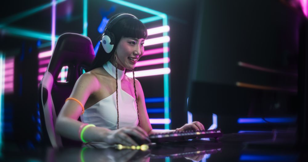 Excited Japanese Cosplayer Playing Video Games with Friends on a Computer, Surrounded by Cyberpunk Style Background.