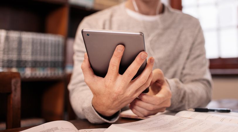 Cropped shot of male holding tablet in hand