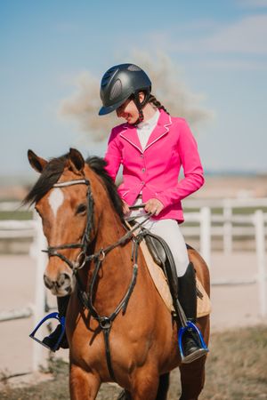 Teen girl riding horse