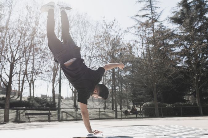 Man dancing break dance in park