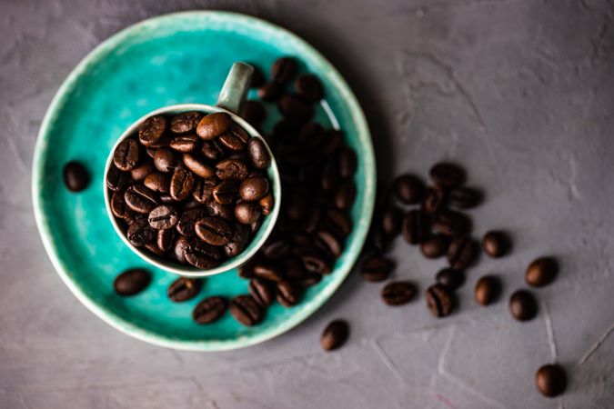 Top view of teal cup with coffee beans