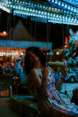 Woman enjoying ride on carousel