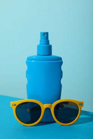 Means for safe tanning, on the background of the sea, flatlay.