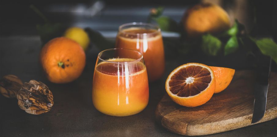 Two glasses of freshly squeezed blood orange juice, wide composition