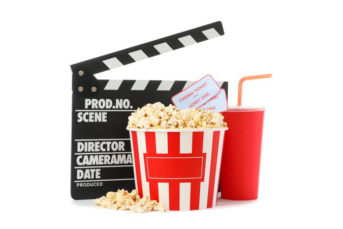 Movie clapper, paper cup, bucket with popcorn and tickets isolated on blank background
