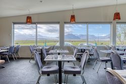Dinning room with wonderful view of summer mountain landscape from window in hotel