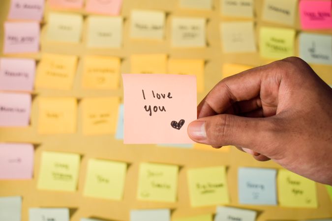 Hand hold sticky notes with words I love you