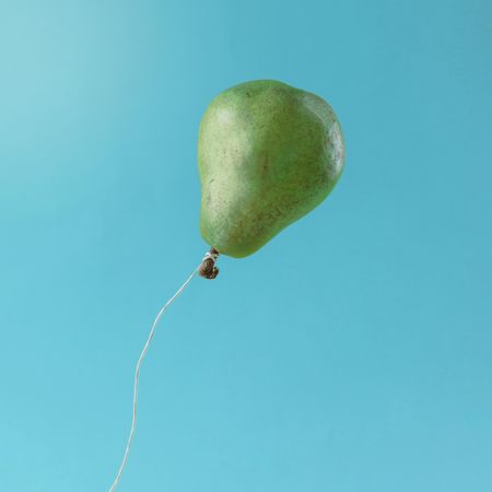Balloon made of pear on blue background