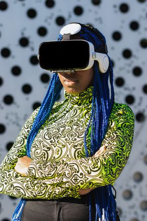 Black woman in VR headset in city