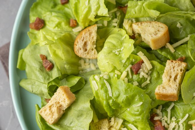 Caesar salad with croutons and bacon.