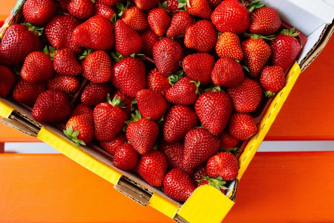 Vibrant Red Strawberries in Bright Container