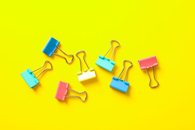 Flat lay composition with clips on color background, space for text