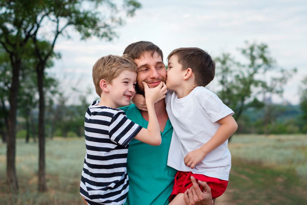 Loving father with two sons outdoors