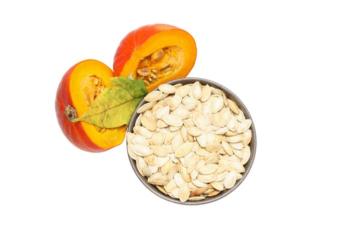Fall season food - pumpkin seeds, isolated on blank background