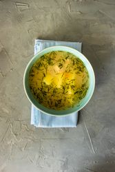 Bowl of healthy chicken soup on napkin