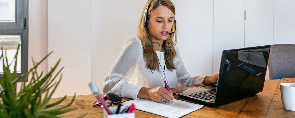 Young woman with headset in customer service of coworking