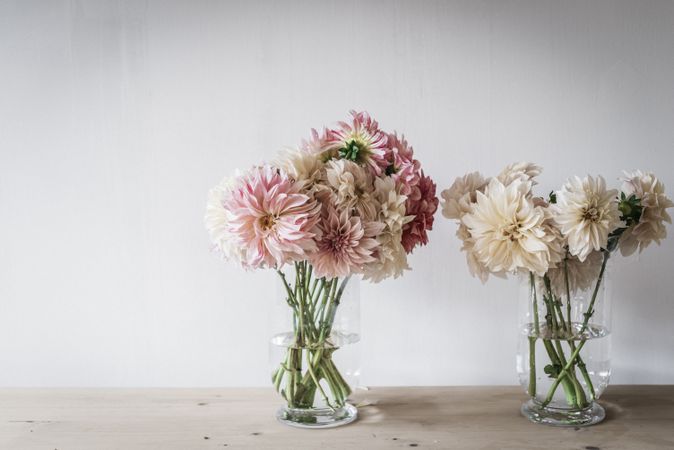 Bunches of flowers in vases on table