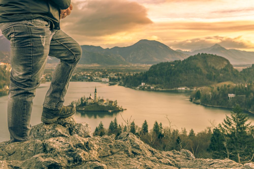 Man climbed on rocks at sunrise