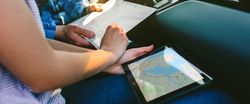 Couple comparing paper map and a gps navigator