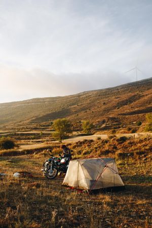 Man with motorcycle and tent, portrait