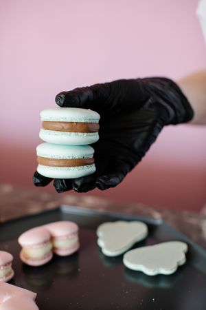 Person holding two macarons