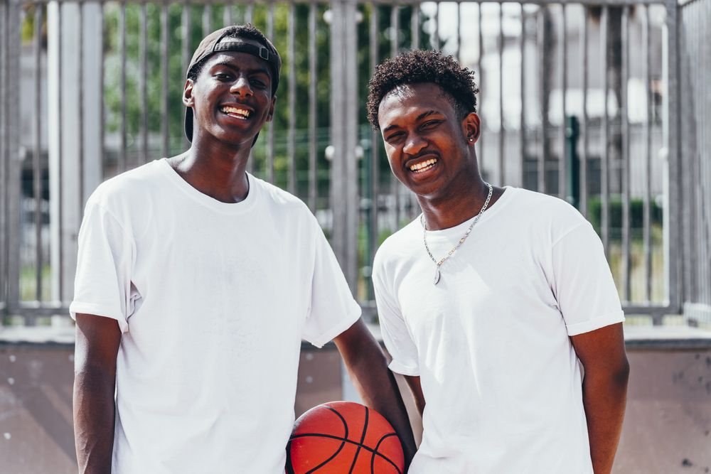 Black sportsmen with ball looking at camera