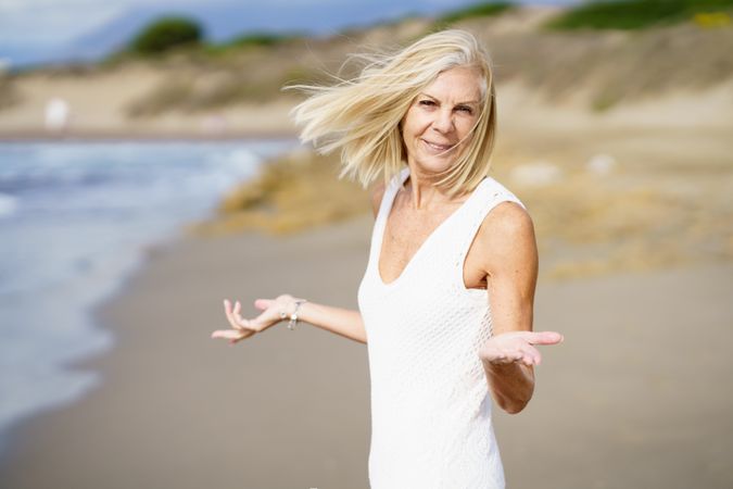 Curious mature woman with her arms making questioning gesture