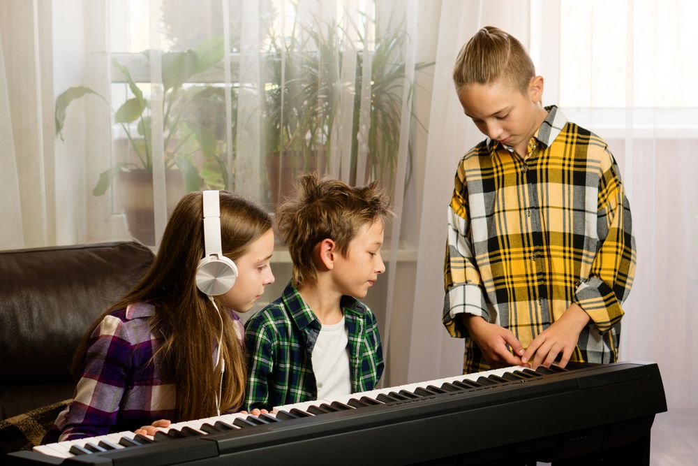 Focused Trio at Piano Lesson