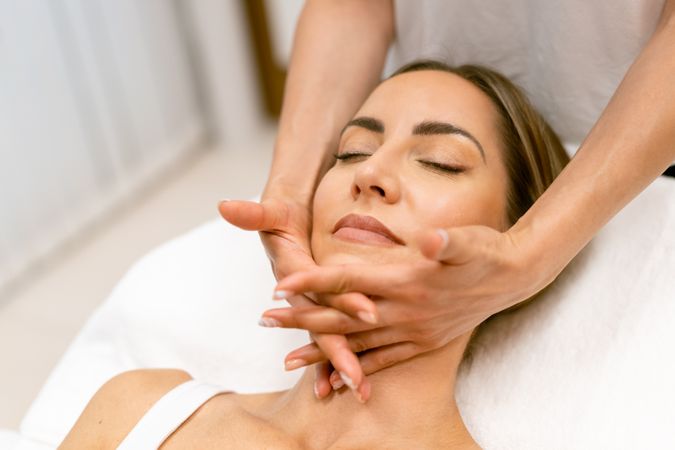 Woman having relaxing face massage