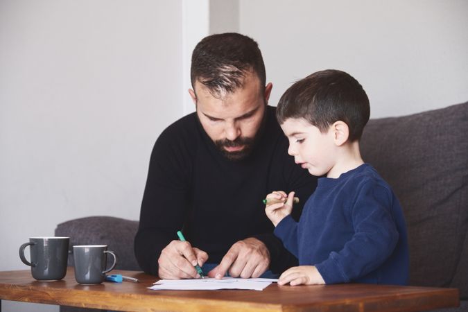 Father and son drawing together