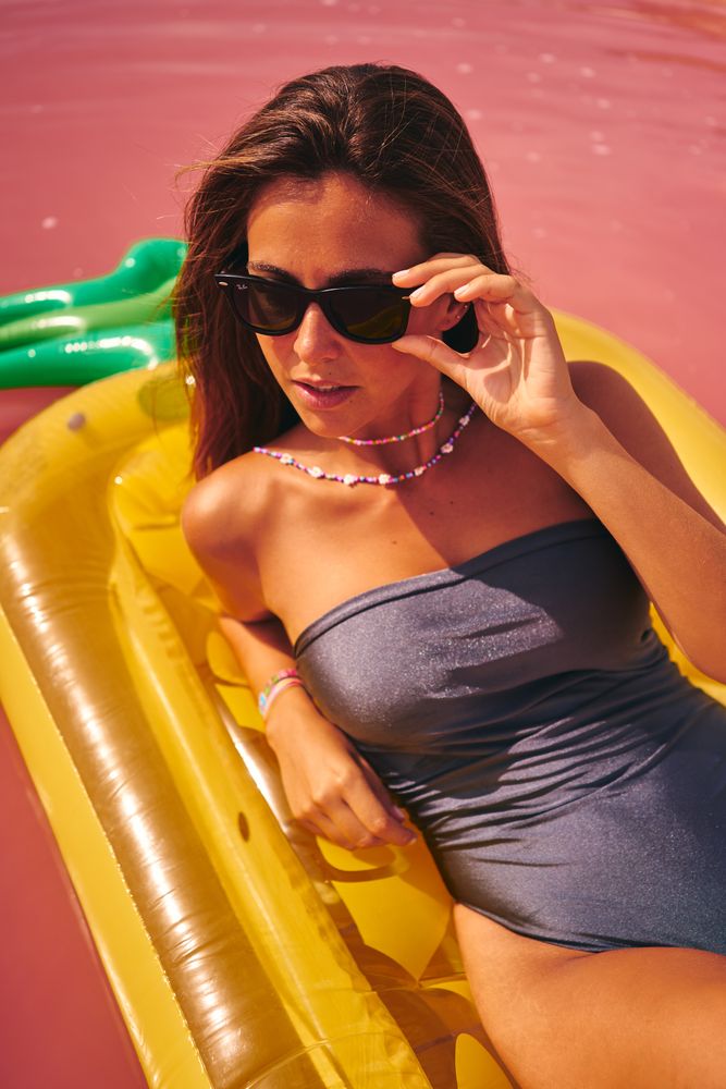 Dreamy female resting on inflatable mattress