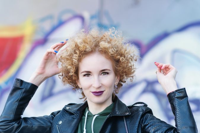 Smiling young woman with curly hairstyle