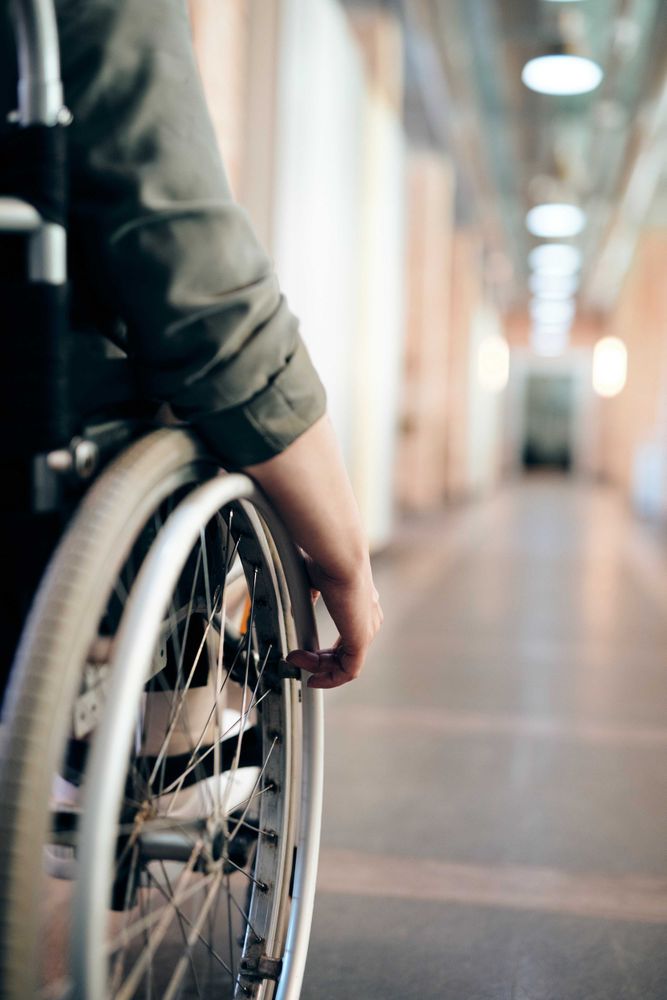 Person on wheelchair in hallway