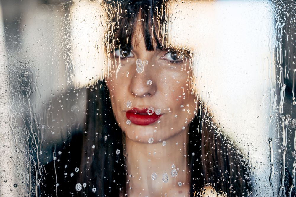 Stylish woman kissing glass