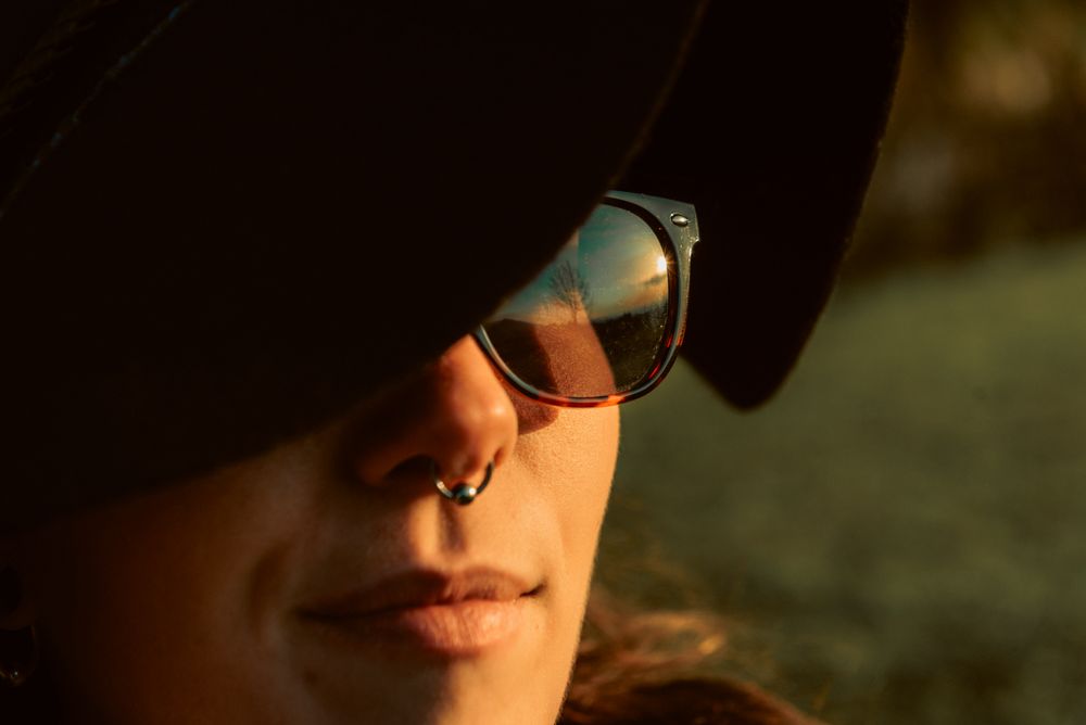 Stylish young woman in hat outdoors