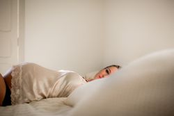 pregnant woman lying on bed