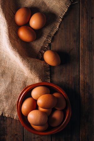 Chicken eggs on napkin on wooden table
