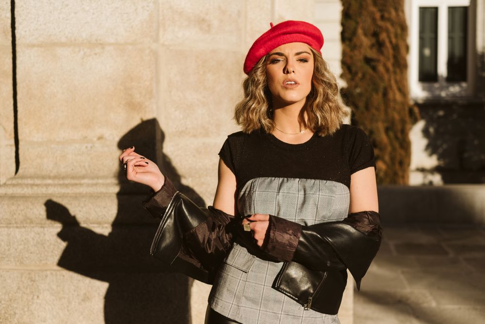 Stylish female in beret looking at camera