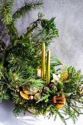 Holiday center piiece with candles and cinnamon sticks